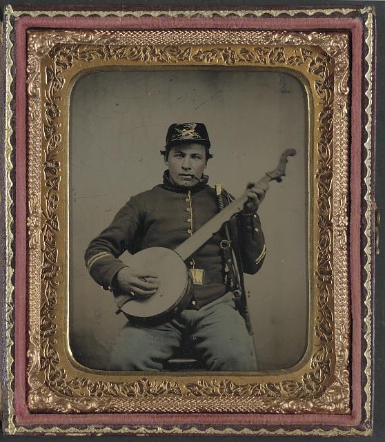 [Unidentified soldier in Union cavalry uniform with banjo, sword, and pipe]