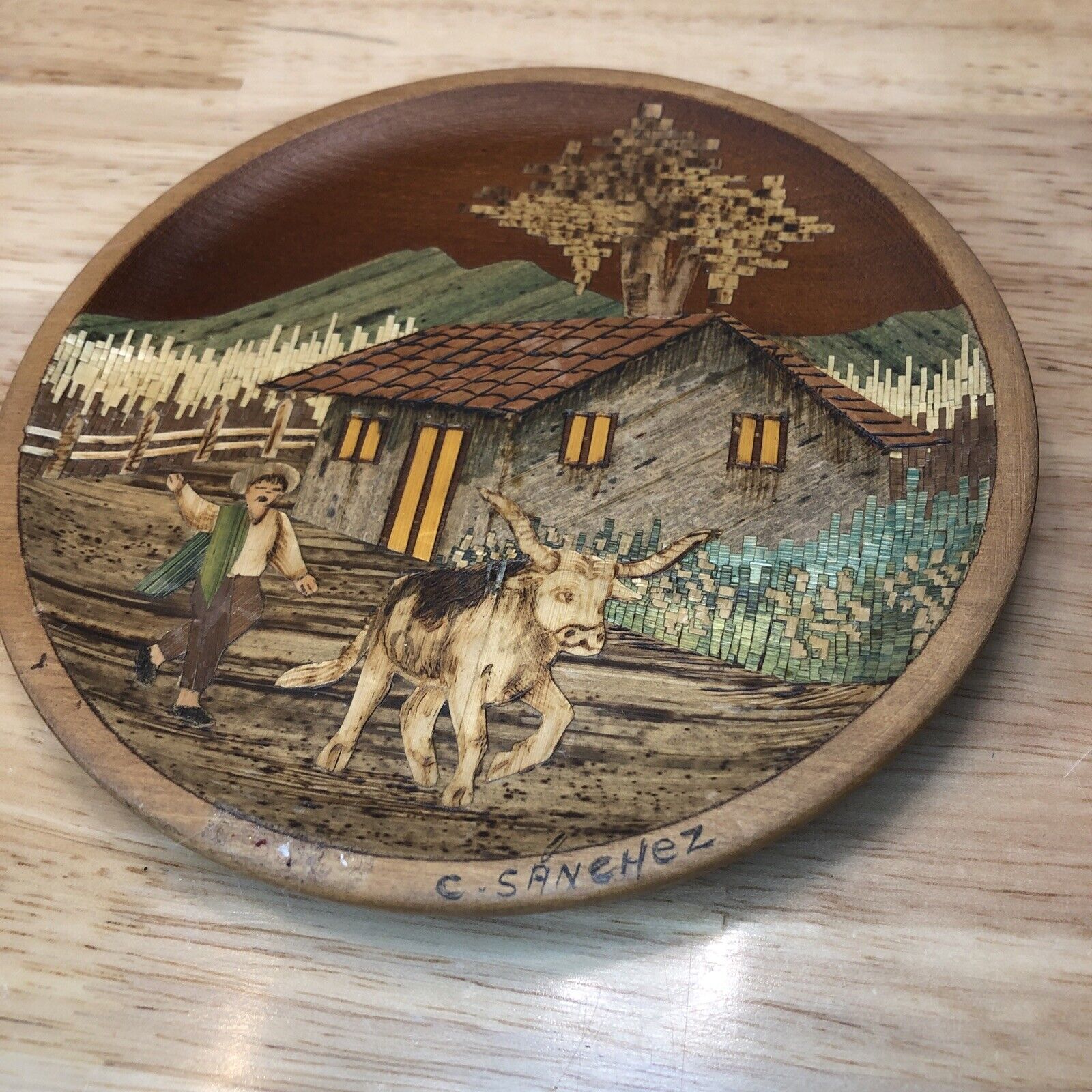 Carved wooden plate - artwork of countryside barn farmer and bull by C. Sanchez