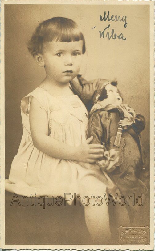 Funny girl posing with porcelain doll jester with guitar antique toy rppc photo