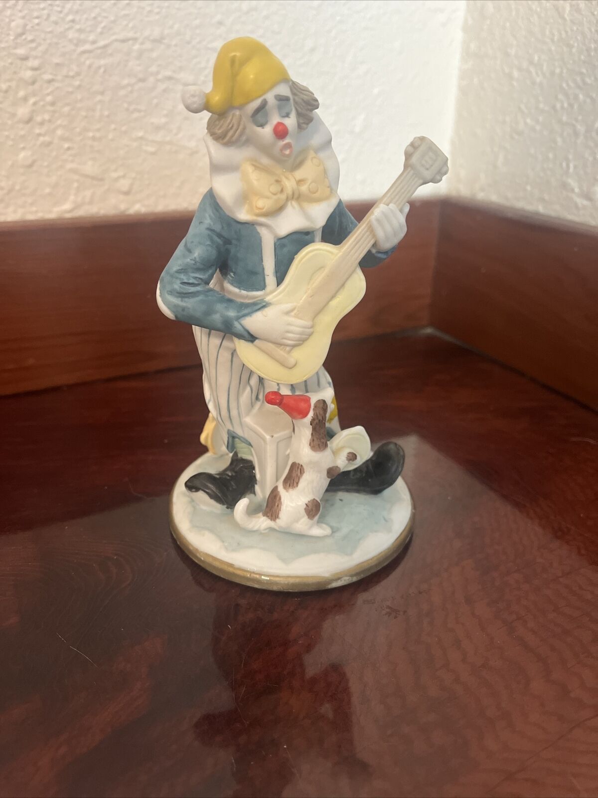 Glass Clown Playing A Guitar With A Dog