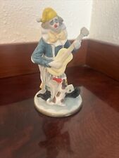 Glass Clown Playing A Guitar With A Dog picture