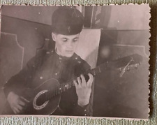  Guitar.    A young handsome guy plays the guitar.   Vintage  picture