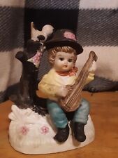 porcelain figurine boy playing a banjo picture