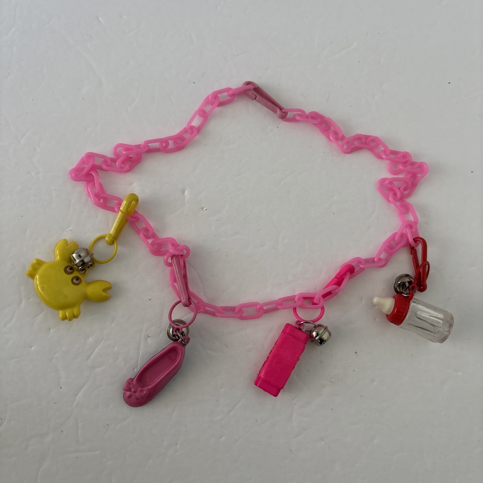 1980's Vintage Plastic Clip-On Bell Charm Necklace Pink Harmonica Ballet Crab