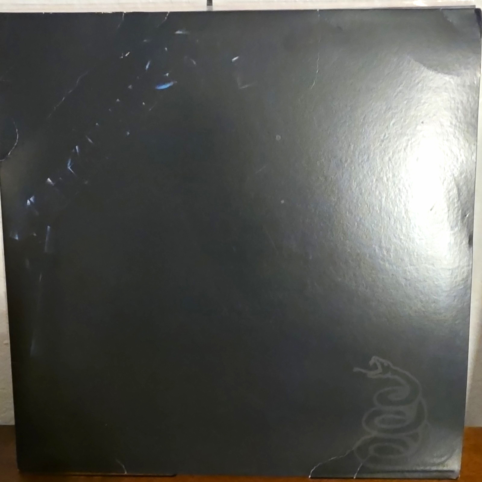 Metallica Black Vinyl Record in Black Cardboard Sleeve, No Text Visible