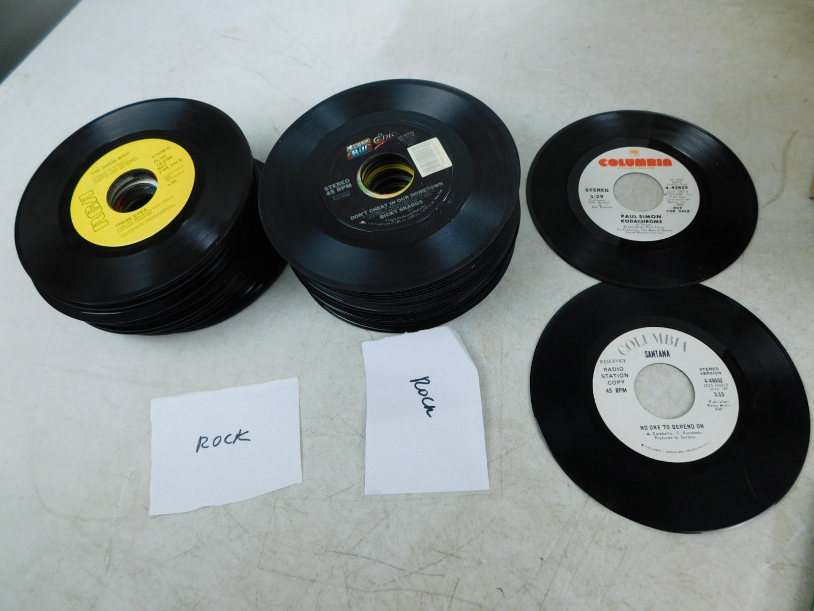 ~100 45 RPM Records Famous Rock Music Stones Skaggs Lennon Dylan Queen Baez +