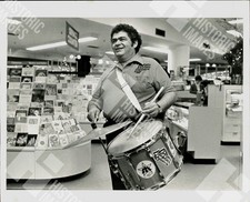 1983 A man is playing drums in a store picture